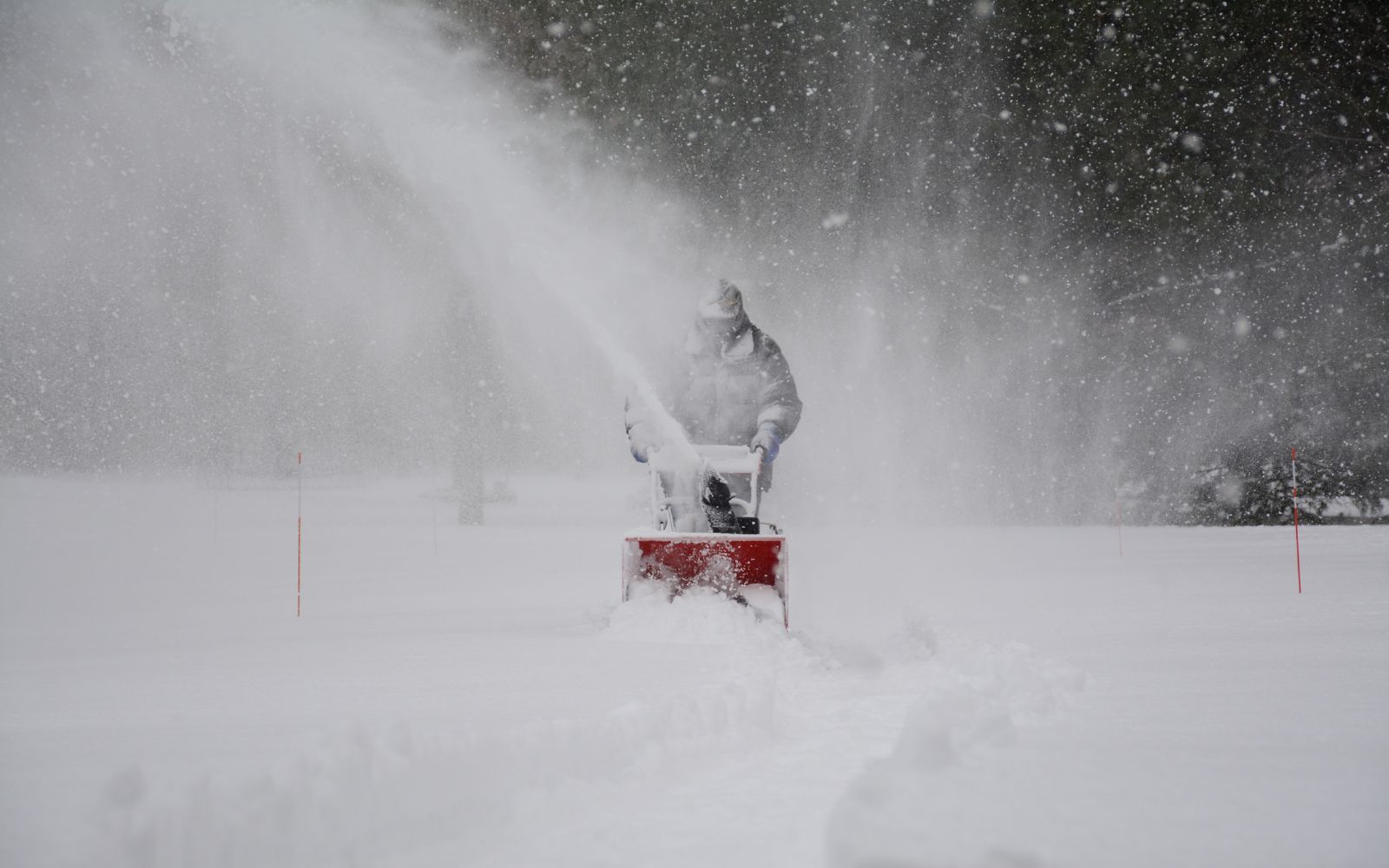 Man Blowing Snow With Electric Blower