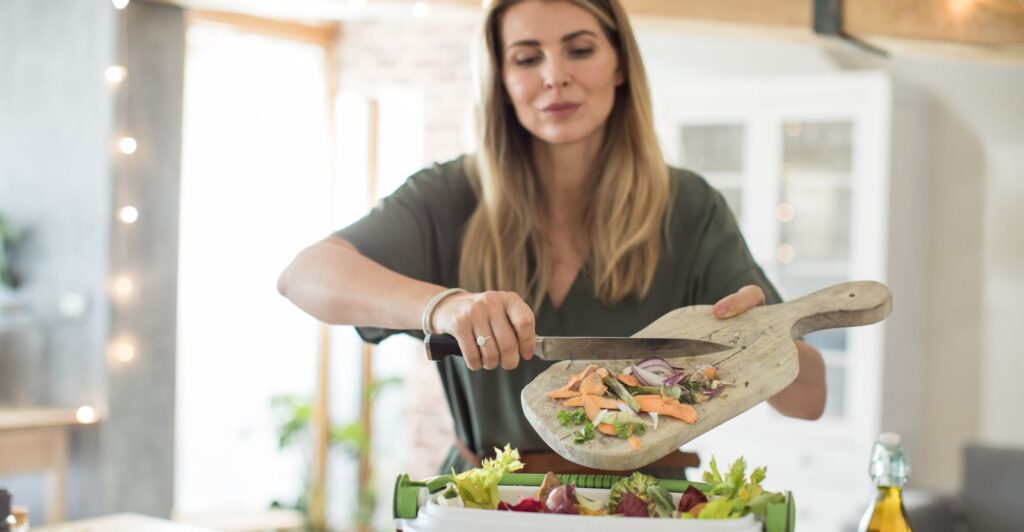 Woman Composting Vegetable